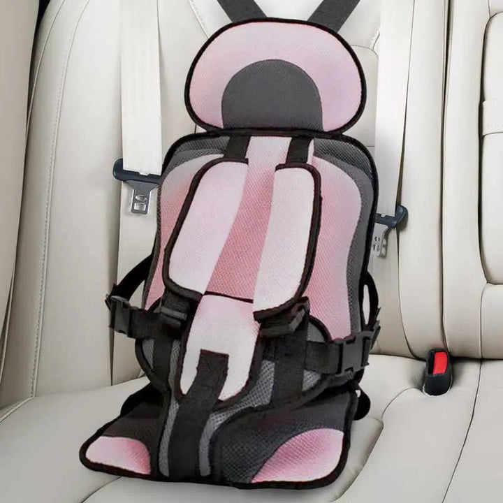 "Child safety car cushion seat in bright red with comfy padding and adjustable straps for secure, cozy travel."