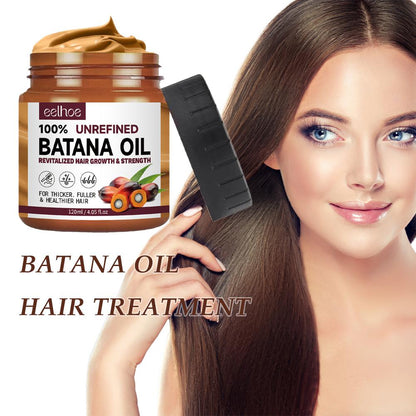 Clear bottle of 100% pure Batana oil for hair and skin care, shown against a plain background, highlighting its rich texture.