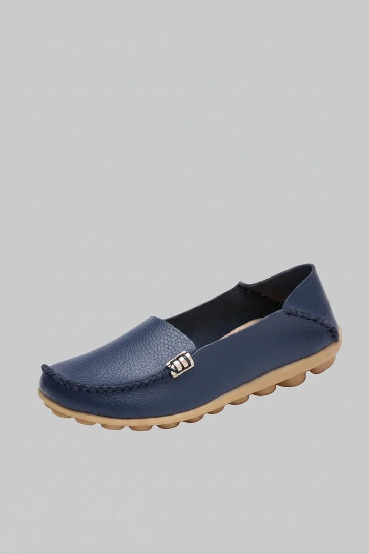 Side profile of a comfortable women's round toe flat, highlighting its sleek, versatile design.