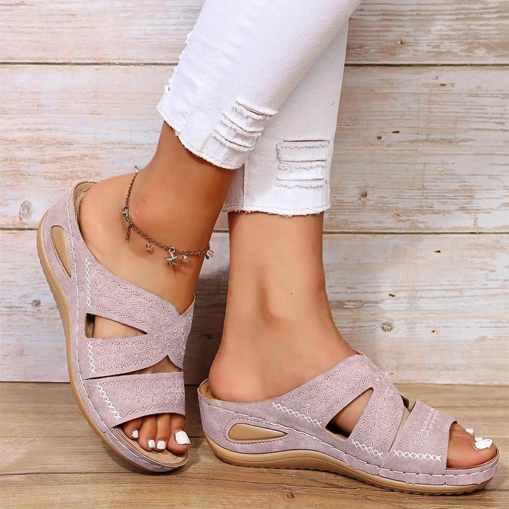 Supportive women's orthopedic cross-strap sandals, designed for adjustable comfort during walking & daily wear.