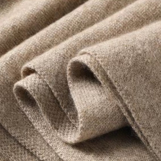 Women's warm beige knit shawl wrap, an essential accessory for colder seasons.