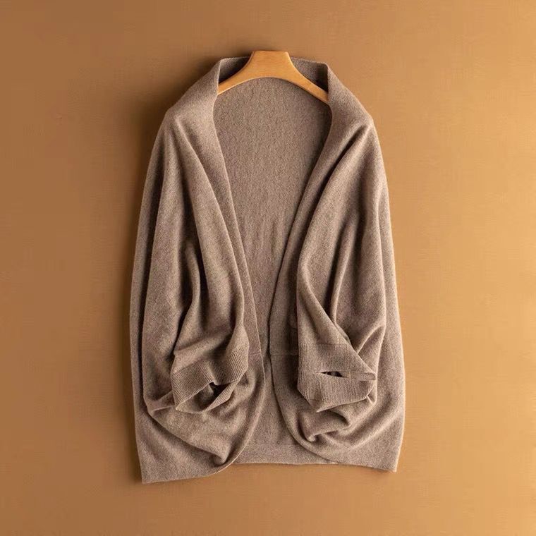 Warm tan knit shawl wrap, a versatile women's accessory for elegant layering.
