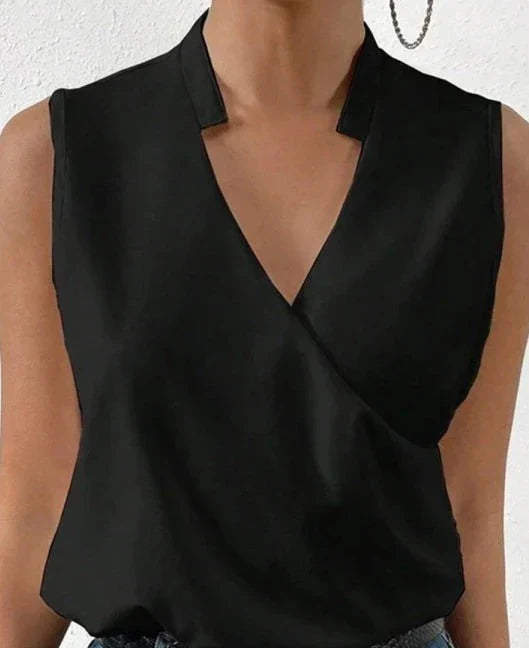 Elegant black sleeveless women's top, flattering fit, highlighting shoulders, ideal for casual or formal occasions.