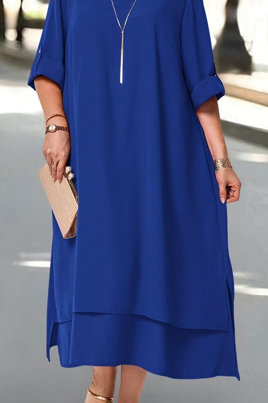 Woman posing gracefully in a blue maxi dress, elegant flowing design, perfect sophisticated women's fashion statement.
