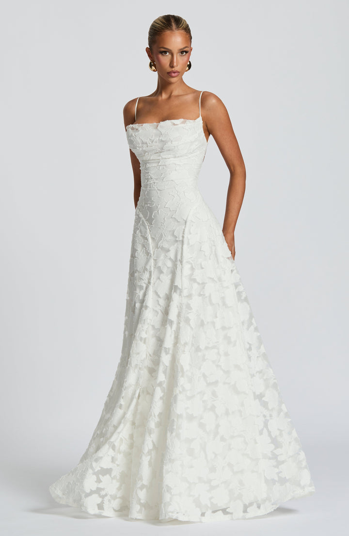 Women's elegant A-line maxi gown with a beautiful textured floral pattern, perfect for formal wear.