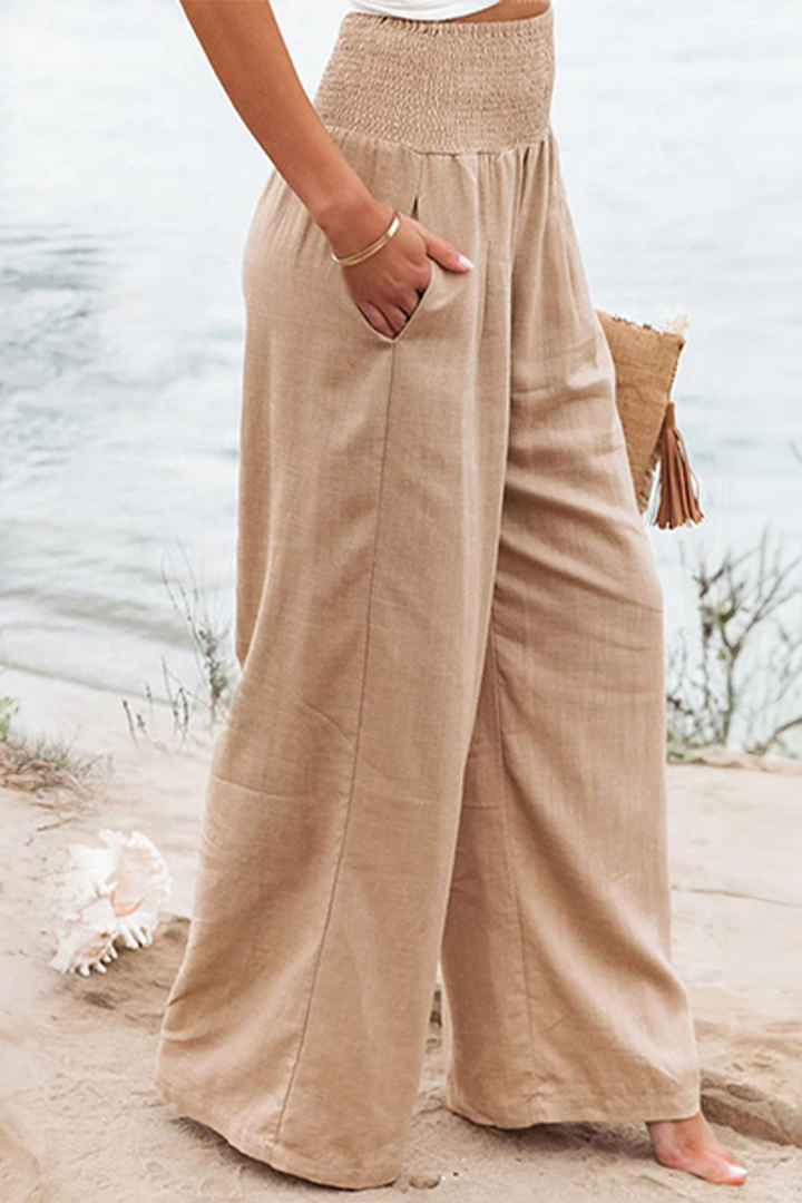 Flowy high-waist palazzo trousers for women, ideal for an effortless boho summer vacation outfit.