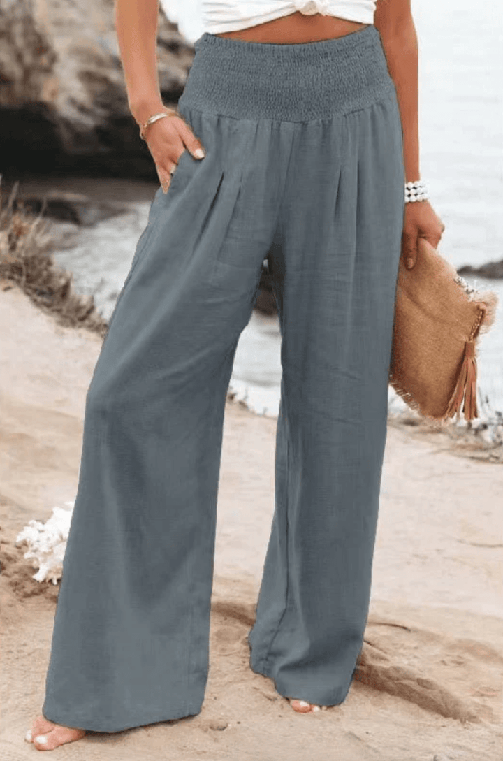 Flowy women's palazzo pants, chic high-waist and wide-leg design for elegant boho summer fashion.