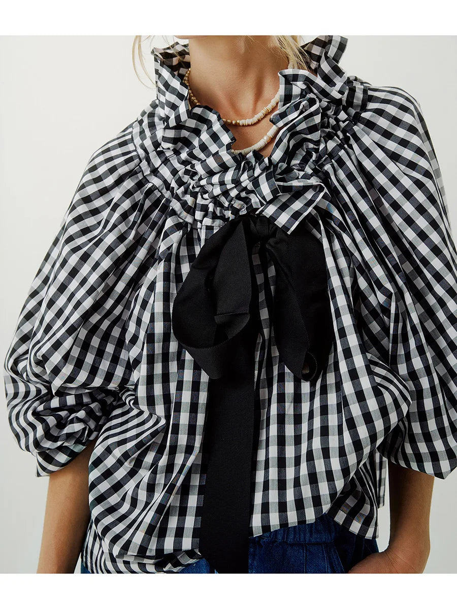 Elegant white women's blouse with puffed lantern sleeves and ruffled neck bow tie, perfect for fashion.