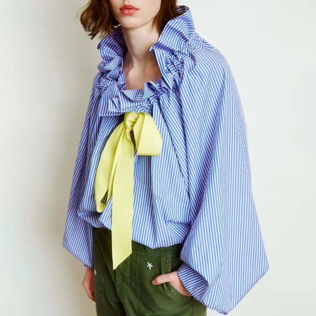 Women's white blouse, elegant design with ruffled bow tie neck and statement puffed lantern sleeves.