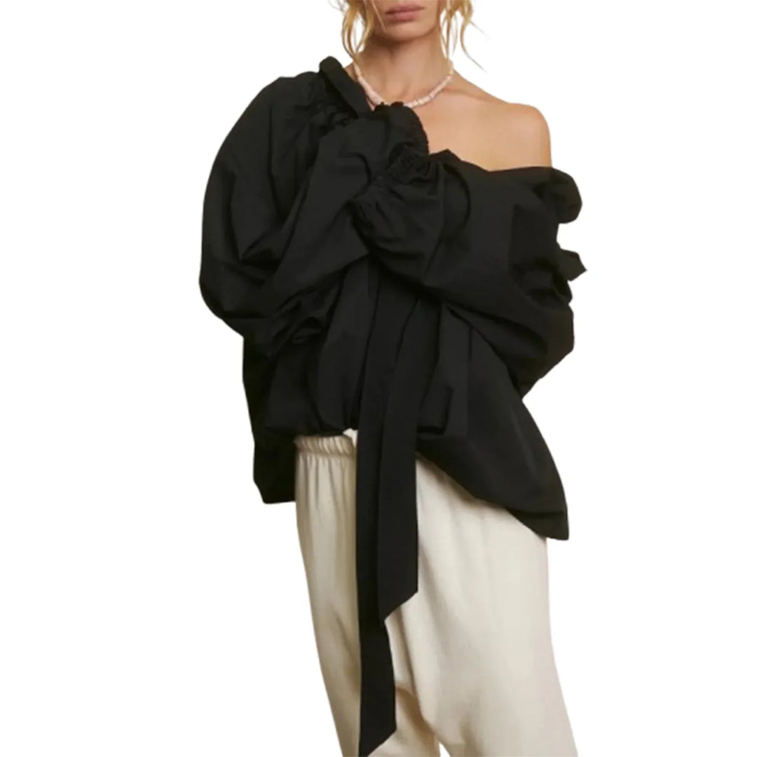 Close-up of fabric texture on a white women's top with elegant puffed lantern sleeves, cotton blend.