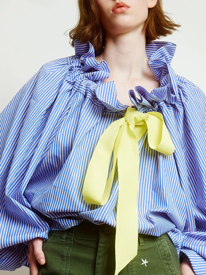 White cotton blend women's top featuring elegant puffed lantern sleeves and a stylish ruffled neck bow tie.