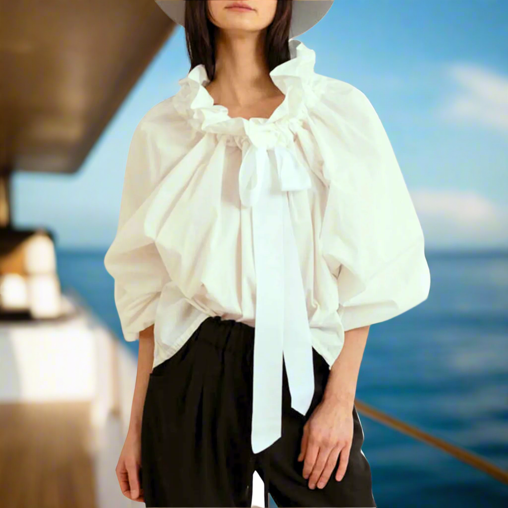 White women's elegant blouse, a perfect blend of style with ruffled neck, bow tie, and puffed lantern sleeves.