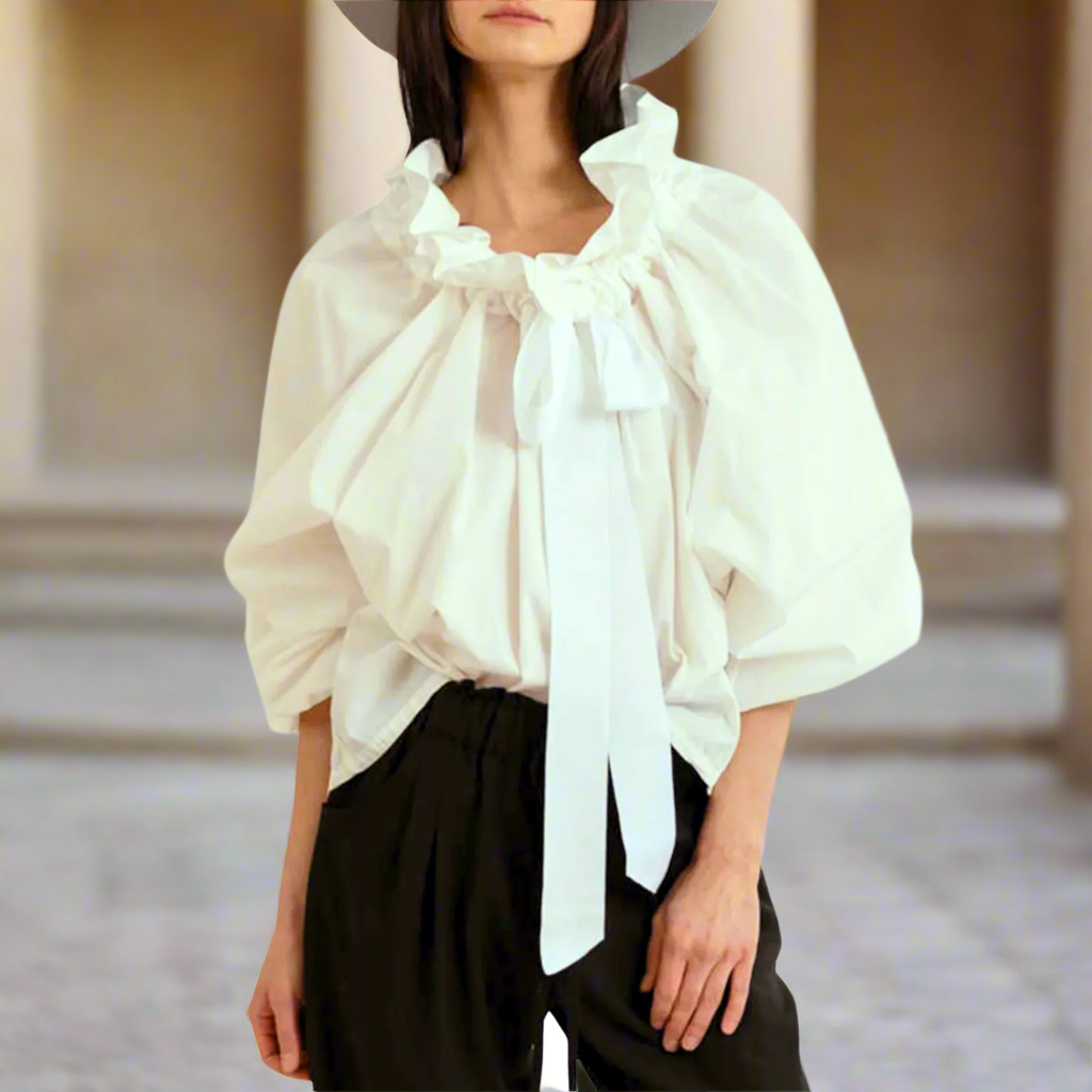 Stylish white women's top, an elegant choice featuring captivating puffed lantern sleeves and bow tie.