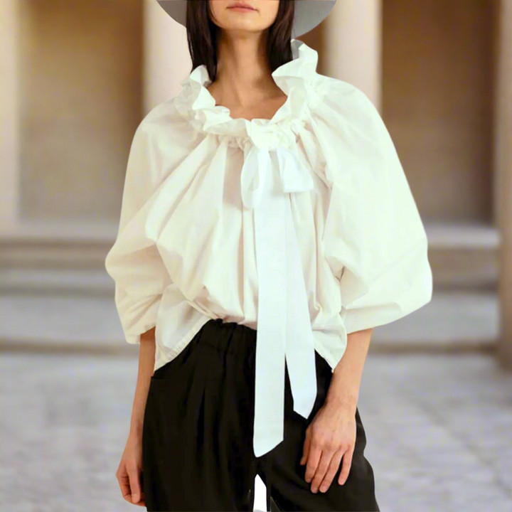 Stylish white women's top, an elegant choice featuring captivating puffed lantern sleeves and bow tie.