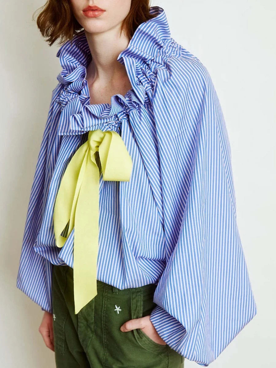 Front view of an elegant white women's blouse, featuring ruffled neck and dramatic puffed lantern sleeves.