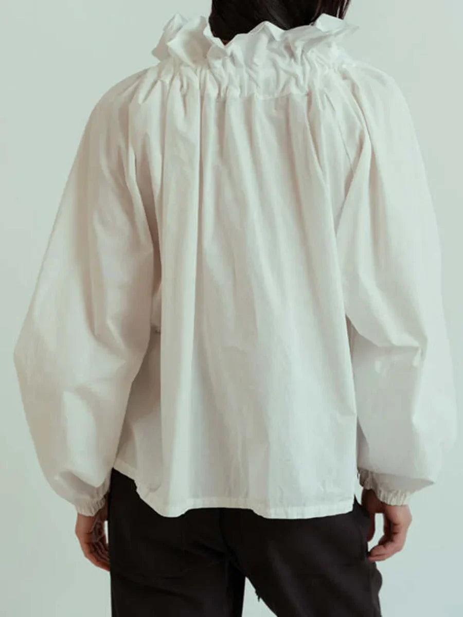 Back view of a chic white women's top with long puffed lantern sleeves and a neat finish.