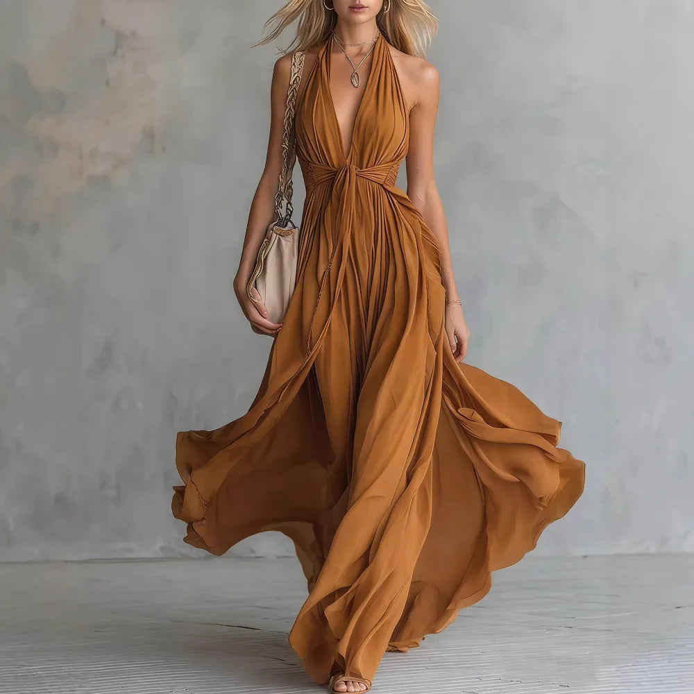 Sophisticated women's flowy pleated backless maxi dress, ideal for elegant evening events. Halter neck style.