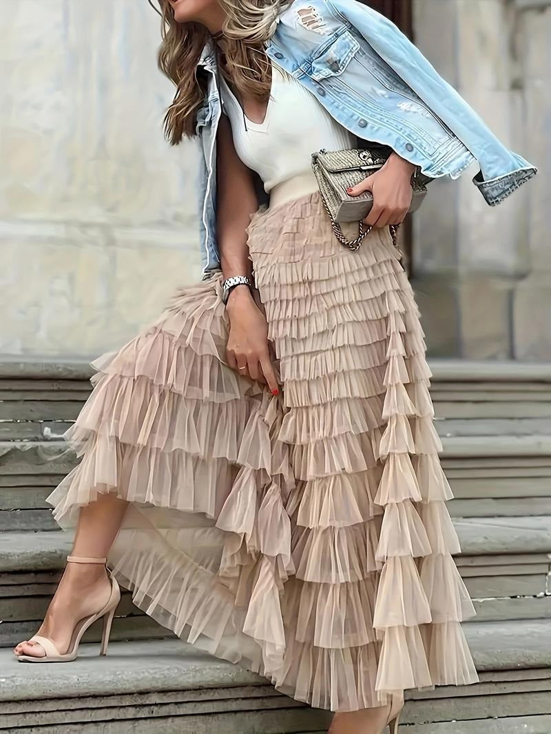 Women's flowy pink tulle tiered maxi skirt styled for an evening event, elegant fashion statement