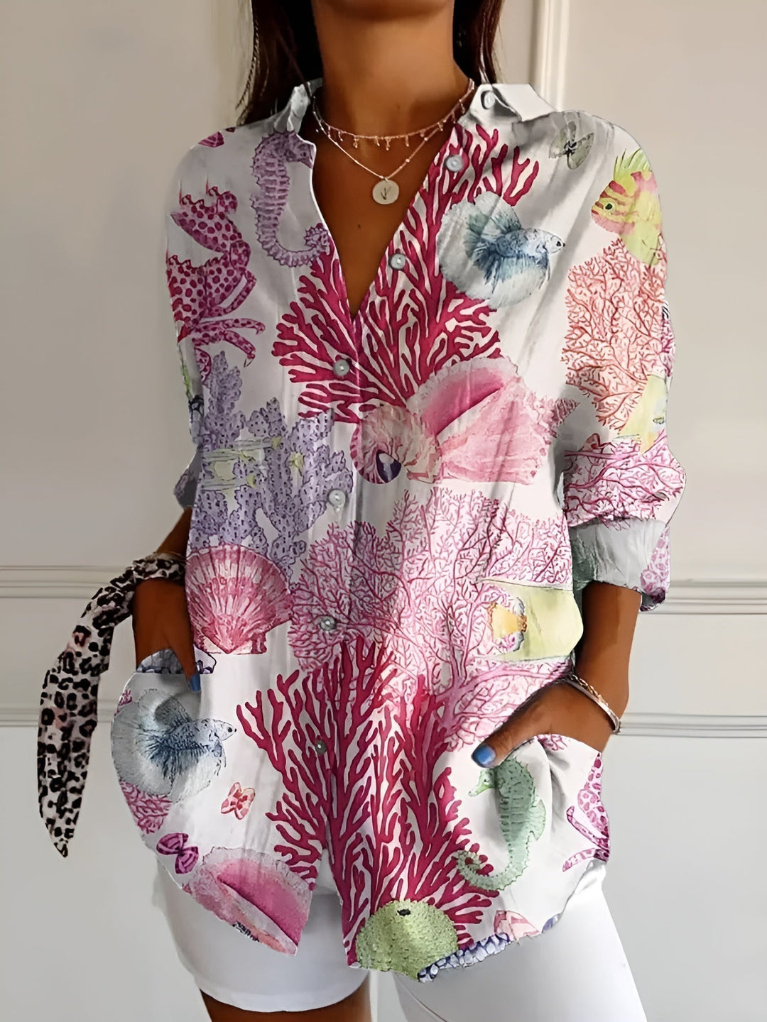 Relaxed fit women's casual blouse with mixed floral prints, button front, and three-quarter sleeves. Stylish.