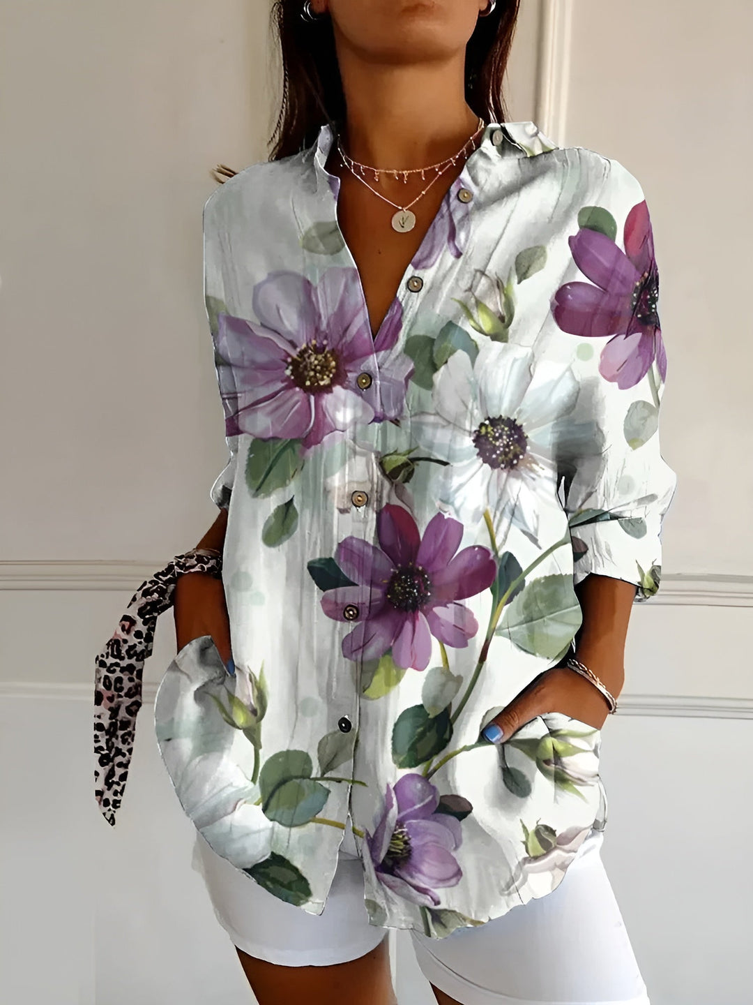 Collared women's blouse. Relaxed fit printed top with three-quarter sleeves, button-front, and chic floral design.