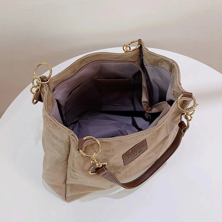 Women's sophisticated brown suede tote bag with sturdy handles, a versatile fashion accessory and work bag.