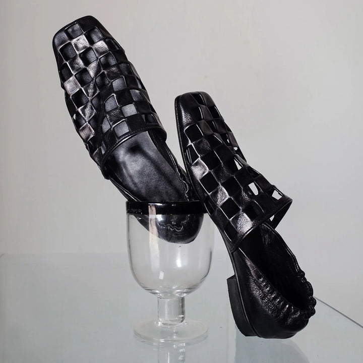 Close-up of women's checkered leather mules, showcasing the detailed pattern and quality craftsmanship.