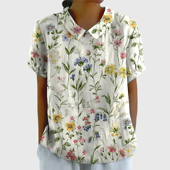 Stylish woman in a relaxed fit floral blouse, paired with jeans, ideal for casual spring & summer fashion.