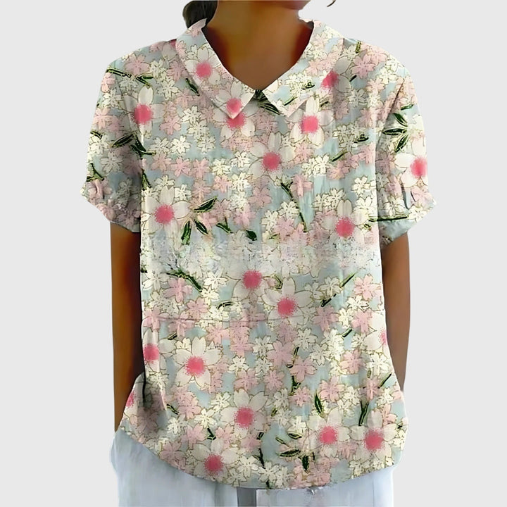 Back view of a comfortable floral women's blouse, highlighting the relaxed fit and flowy, feminine design.