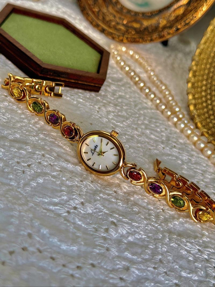 Elegant women's gemstone bracelet watch with multicolor jewels and stainless steel band, perfect fashion accessory