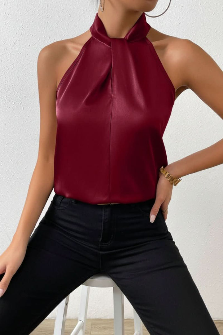 Women's summer sleeveless top with elegant halter neckline and fashionable knot accent.