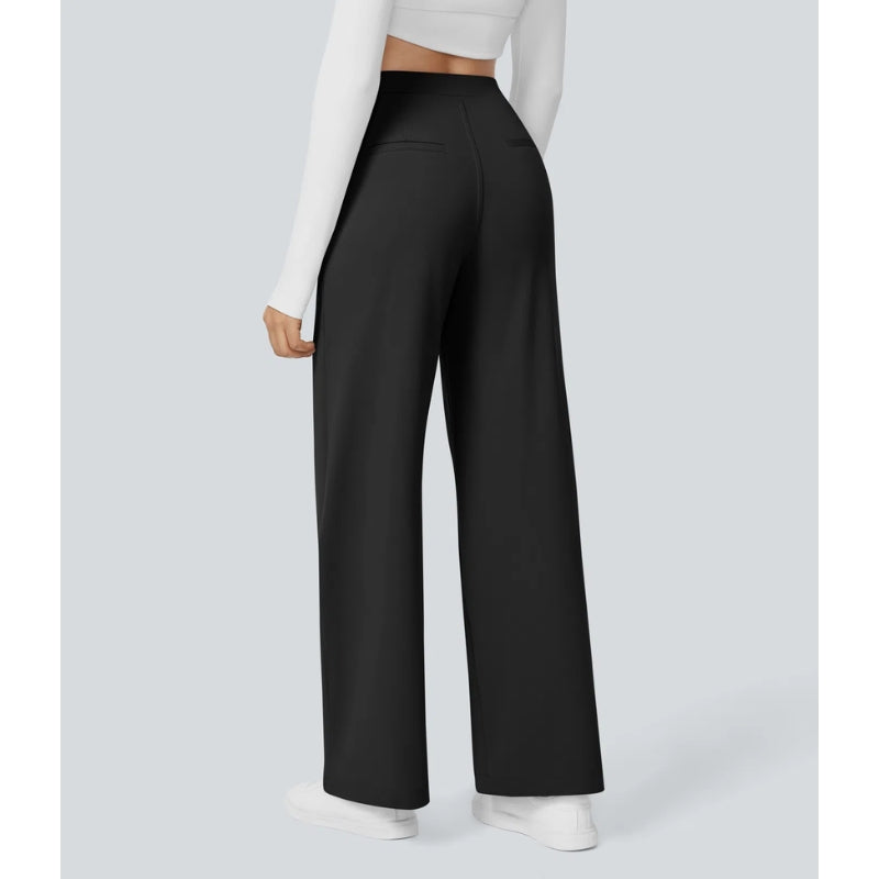 Woman wearing high waisted wide leg tailored pants, showcasing their elegant drape and fit.