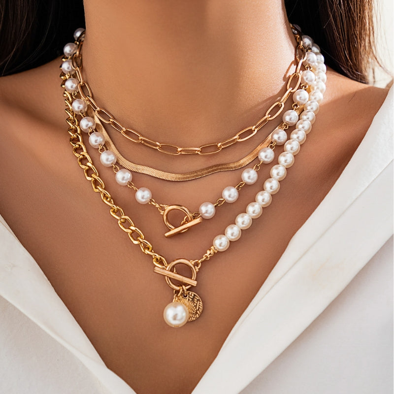 Elegant women's layered necklace featuring multiple strands of varying lengths, white pearls, and gold-tone chains.