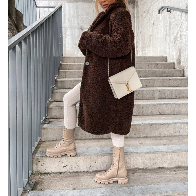 Cozy women's longline winter coat in faux shearling, designed for warmth and a chic, elegant appearance.