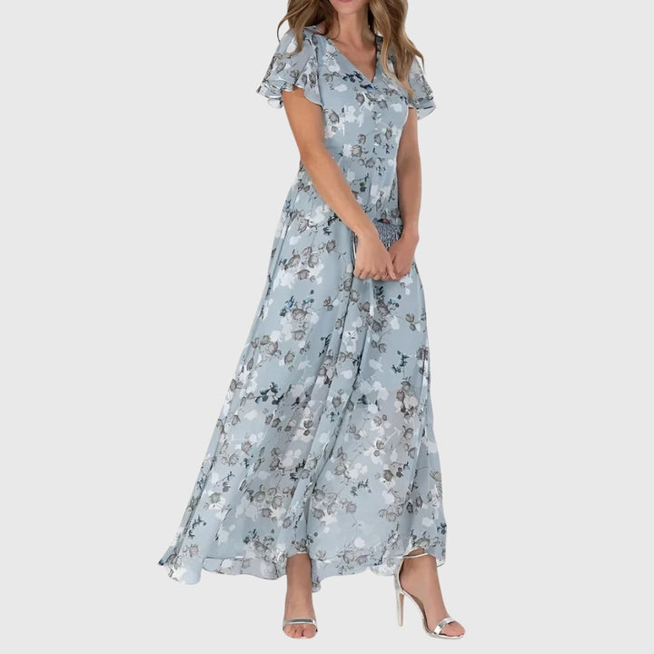 Flowy printed maxi dress for women with flutter sleeves and V-neck, ideal for summer or casual events.
