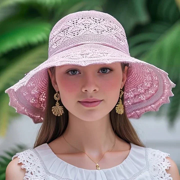 Elegant women's patterned sun hat with wide brim, perfect for stylish sun protection on the beach or travel.