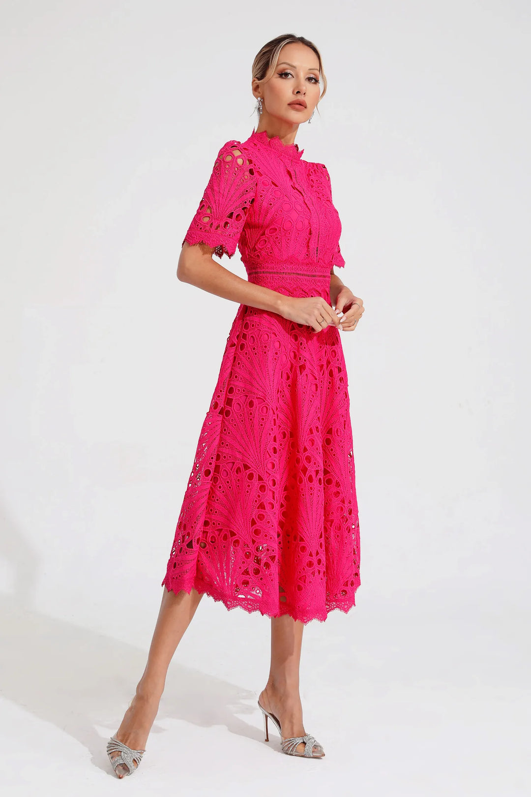 Back view of a women's pink lace midi dress, highlighting the elegant silhouette and design