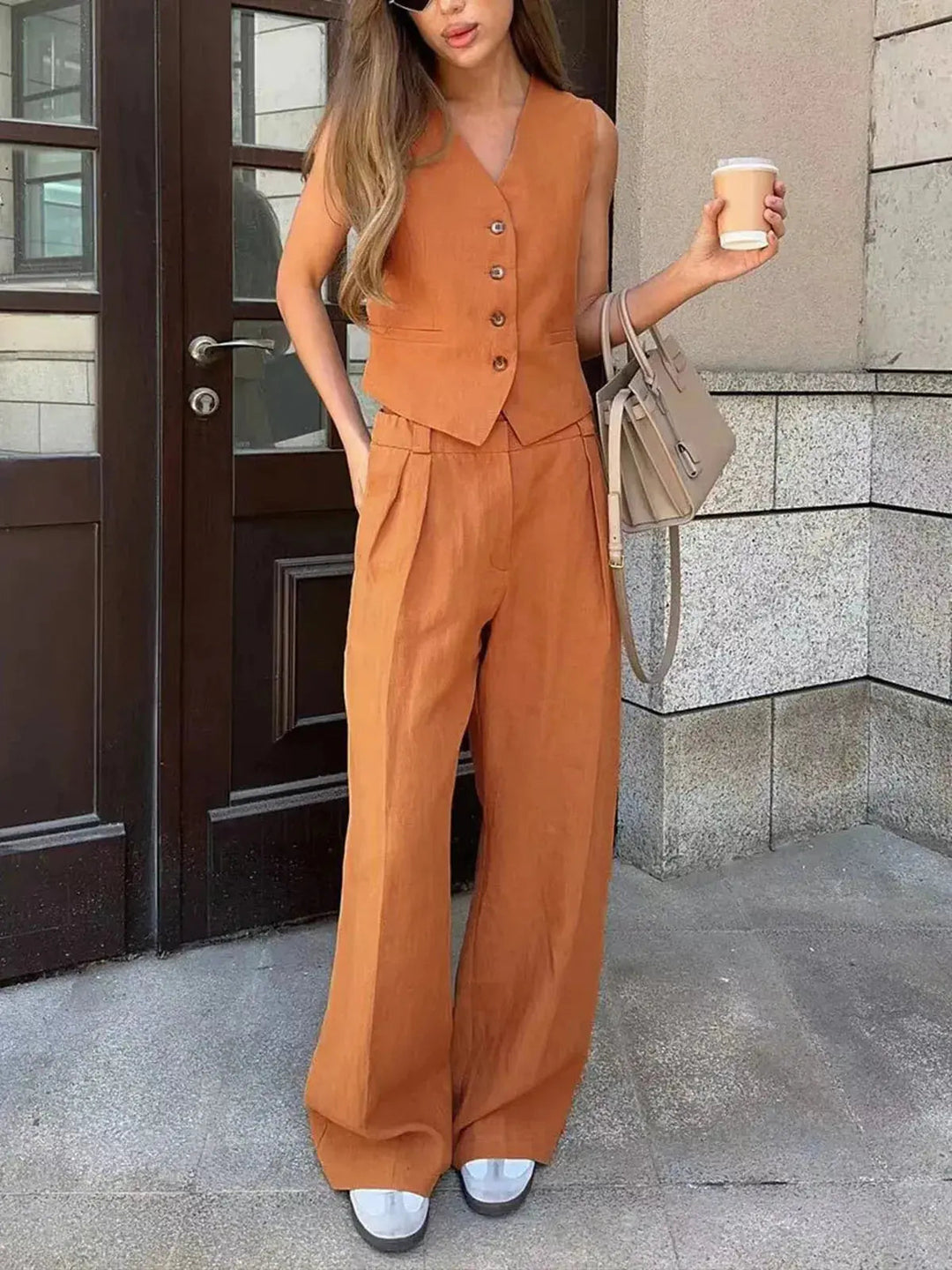 Chic ladies' matching waistcoat and wide-leg pant set. Relaxed fit for comfortable, stylish spring and summer fashion.
