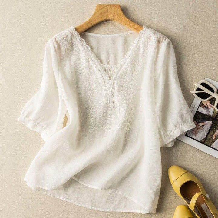 Comfortable women's embroidered V-neck blouse, relaxed fit. Ideal for casual spring and summer outfits.