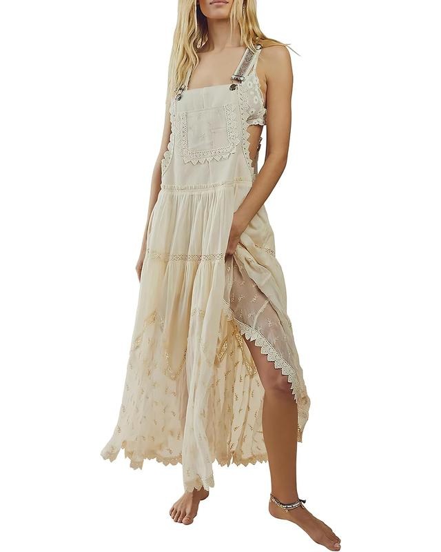 Elegant women's white lace tiered maxi dress with delicate floral patterns, perfect for a summer or bridal event