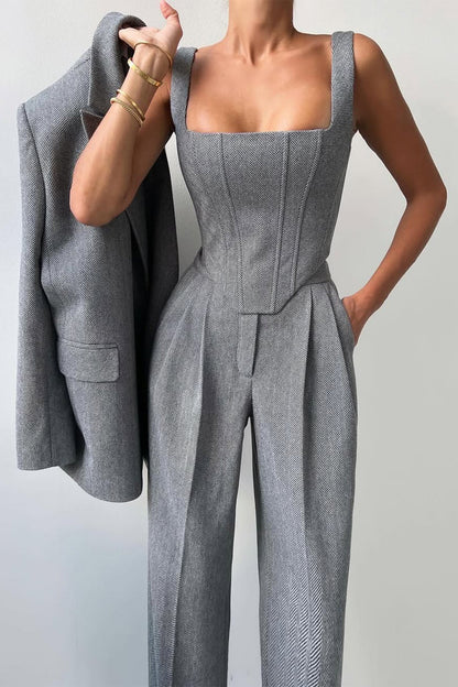 "Elegant women's three-piece suit with structured blazer, bustier top, and wide-leg trousers in classic herringbone weave."