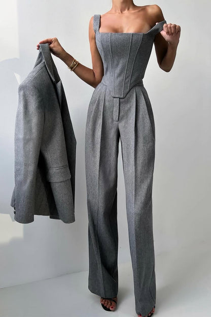 "Elegant women's three-piece suit with structured blazer, bustier top, and wide-leg trousers in classic herringbone weave."