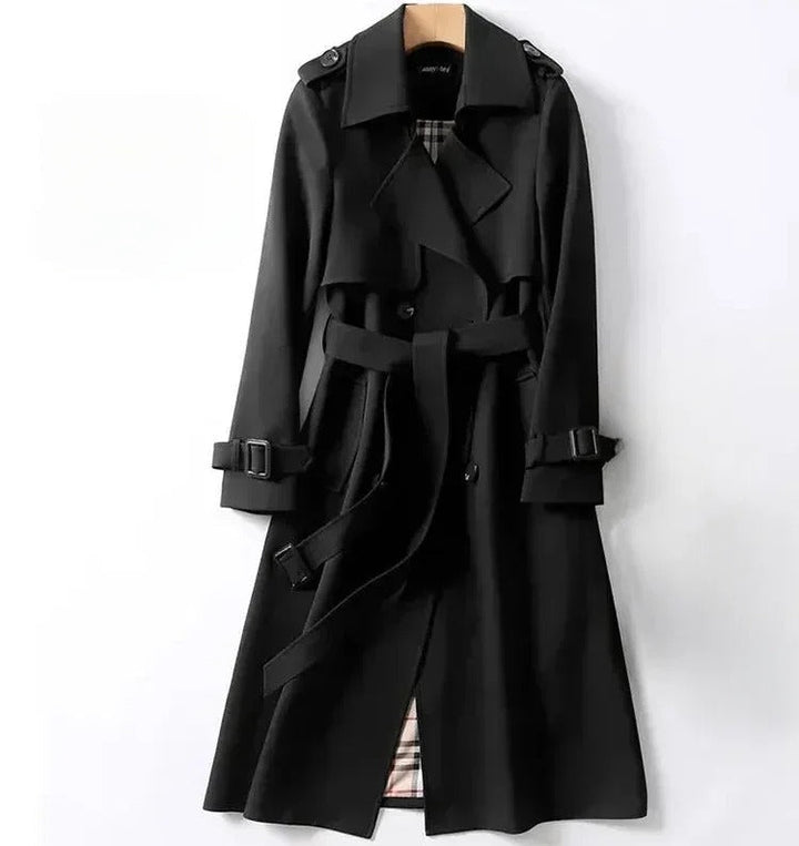 Elegant women's waterproof trench coat with a double-breasted front, waist belt, and storm shields in various colors.