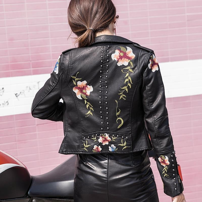 Back view of a women's chic embroidered faux leather biker jacket, showcasing its design.