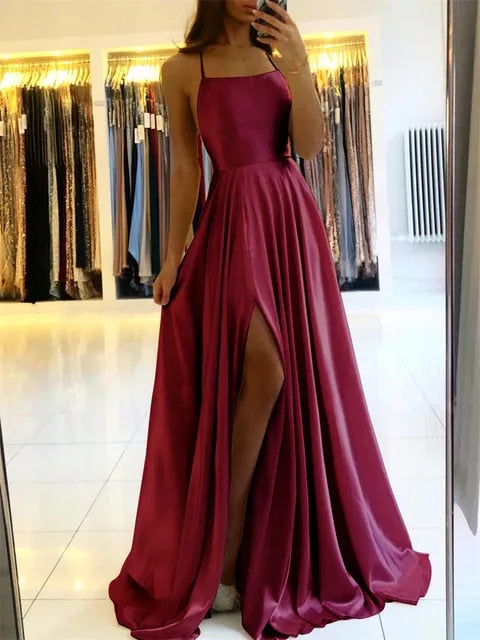 Long, chic women's flowing maxi dress with a flattering side slit, perfect for elegant summer and evening outfits.