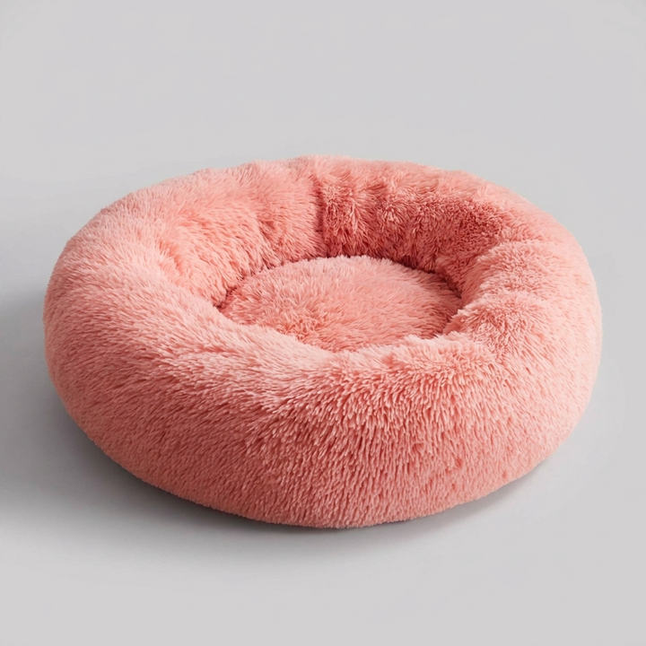Dog nestled in a round plush calming pet bed, experiencing anxiety relief & cozy comfort.