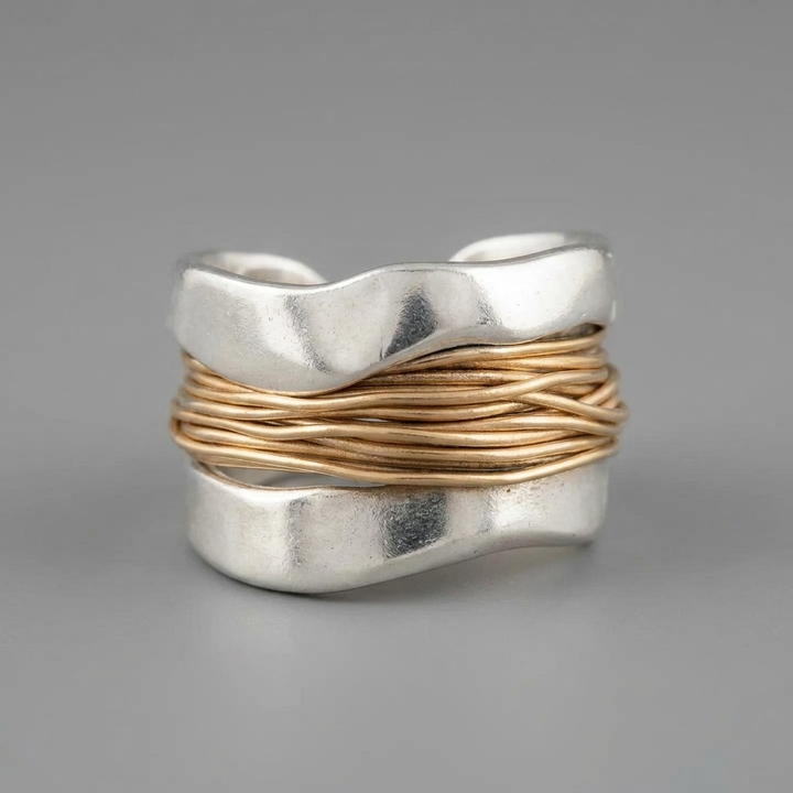 Stunning women's two-tone silver ring with a gold wire accent. Versatile statement jewelry for modern fashion outfits.