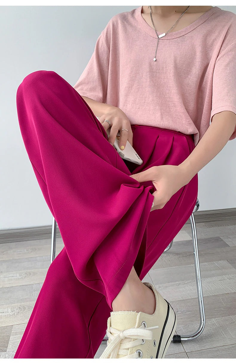 Woman wearing high-waist wide leg casual trousers, showcasing a comfortable, elegant and versatile fit.