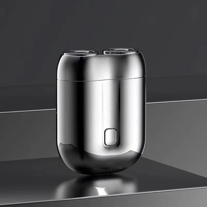 Men's portable electric shaver with magnetic charging, ideal for travel. Rechargeable for a smooth, fast shave.