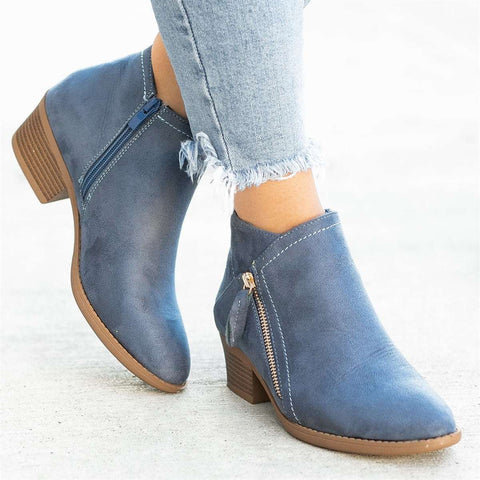 Beige women's stylish zip-up ankle boots, ideal everyday footwear, close up of zipper