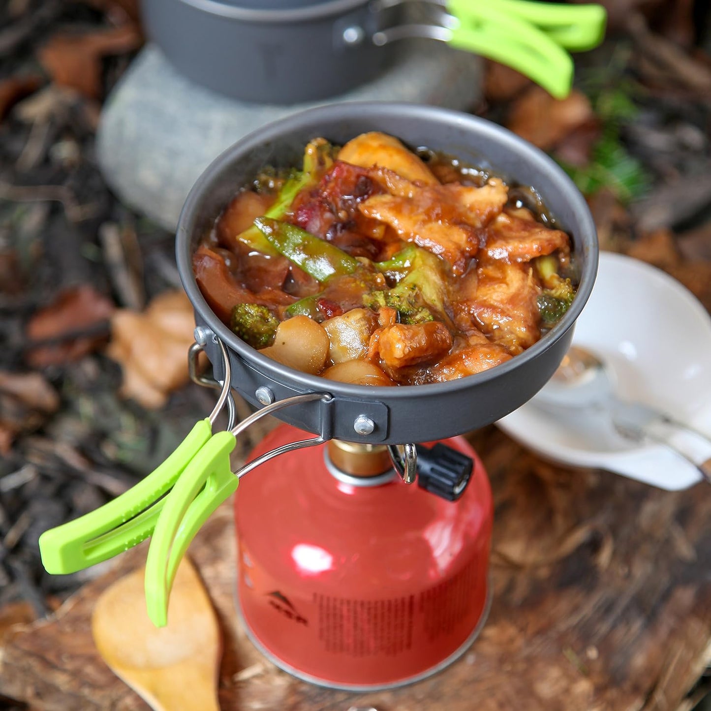 Lightweight camping cookware set for outdoor cooking, includes pot, pan, bowls; anodized aluminum, non-stick, portable.